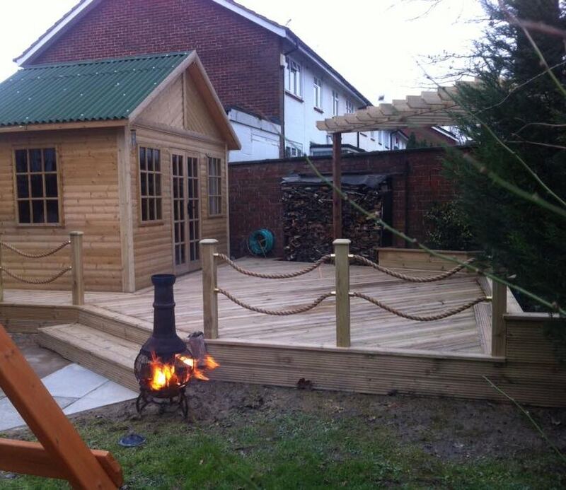 Timber summerhouse with raised decking and pergola