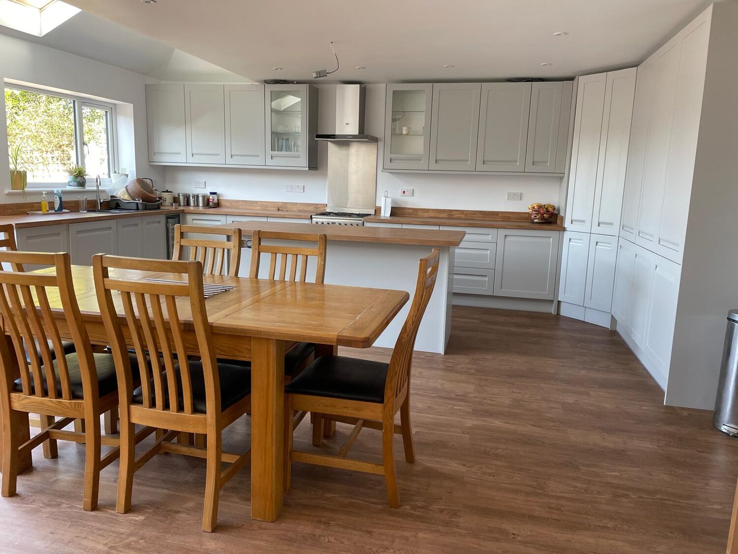Bright open-plan kitchen-diner renovation with shaker units, oak worktops, island and new wood flooring